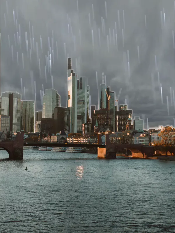 Rain falling over Frankfurt under a storm sky.